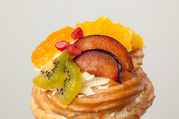 Image showing Closeup of cake with fresh fruits on gray background.