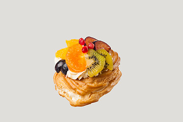 Image showing Closeup of cake with fresh fruits on gray background.