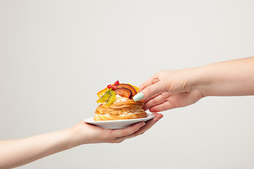 Image showing Closeup of cake with fresh fruits on gray background.