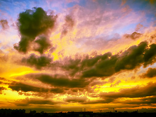 Image showing Dramatic sunset like fire in the sky with golden clouds collage