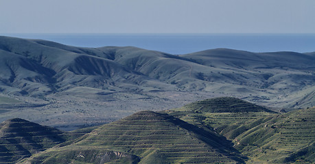 Image showing Crimean barrows on a background of mountains, sea and sky