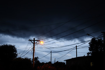 Image showing Street light at night with a stormy sky background