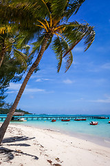 Image showing white sand beach and pier on the lagoon in Moorea Island