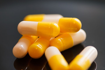 Image showing Yellow-white capsules with medicine, close-up