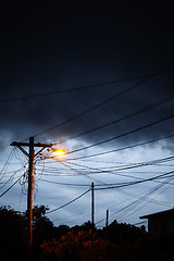 Image showing Street light at night with a stormy sky background