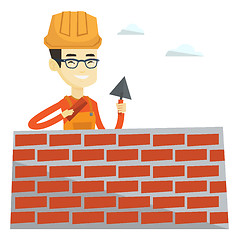 Image showing Bricklayer working with spatula and brick.