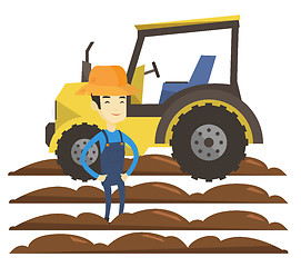 Image showing Farmer standing with tractor on background.