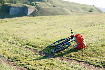 Image showing Bicycle with orange bags for travel