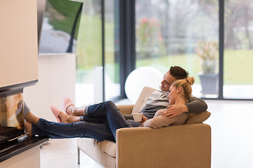 Image showing Young couple  in front of fireplace