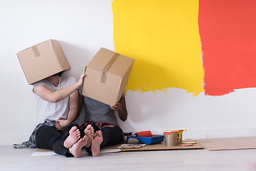 Image showing young multiethnic couple playing with cardboard boxes