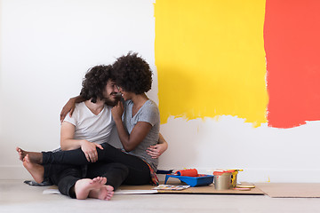 Image showing young multiethnic couple relaxing after painting