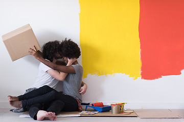 Image showing young multiethnic couple playing with cardboard boxes