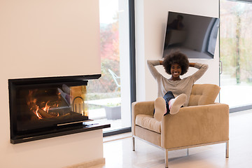 Image showing black woman in front of fireplace