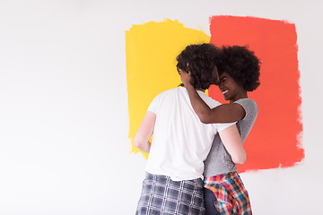 Image showing multiethnic couple painting interior wall