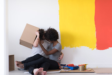 Image showing young multiethnic couple playing with cardboard boxes