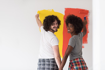 Image showing multiethnic couple painting interior wall