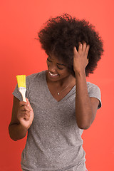 Image showing black woman painting wall