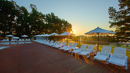 Image showing Relaxing chairs beside swimming pool