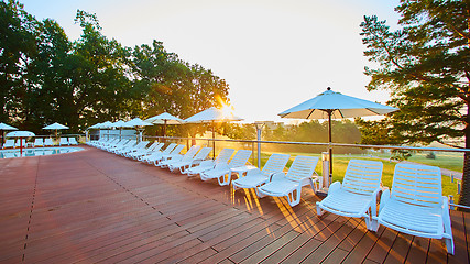 Image showing Relaxing chairs beside swimming pool