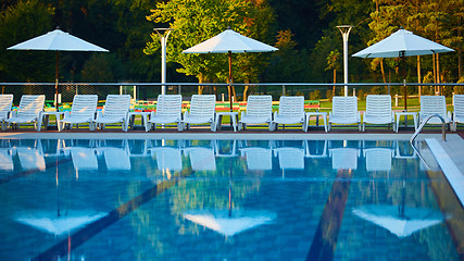 Image showing Relaxing chairs beside swimming pool