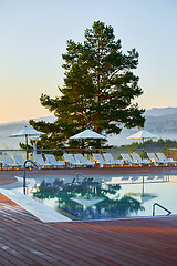 Image showing Relaxing chairs beside swimming pool