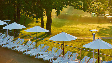 Image showing Relaxing chairs beside swimming pool