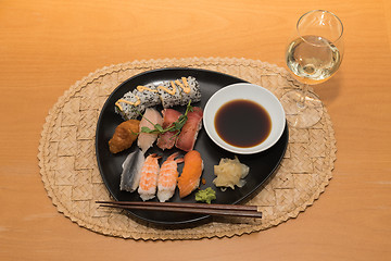 Image showing Sushi meal with white wine