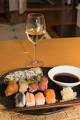 Image showing Glass of white wine and sushi