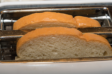Image showing White bread slices in a toaster