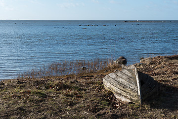 Image showing Abandoned rowboat by the coast