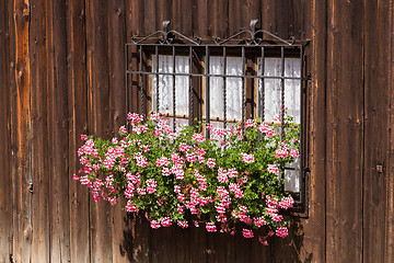 Image showing Window and rough wooden walls with flowers in traditional wabi-s
