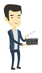 Image showing Smiling man holding an open clapperboard.