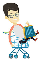 Image showing Happy man riding by shopping trolley.