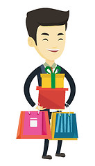 Image showing Happy man holding shopping bags and gift boxes.