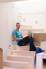 Image showing young man sitting in stairway at home