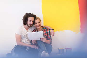 Image showing Happy young couple relaxing after painting