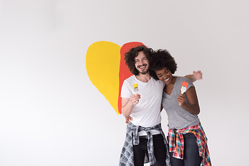 Image showing couple with painted heart on wall