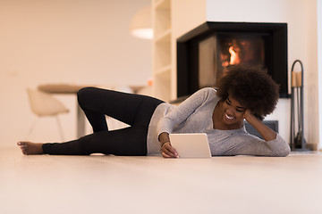 Image showing black women using tablet computer on the floor