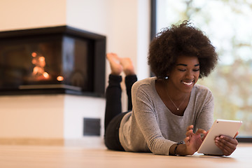 Image showing black women using tablet computer on the floor