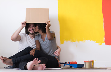 Image showing young multiethnic couple playing with cardboard boxes