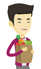 Image showing Happy man holding grocery shopping bag.