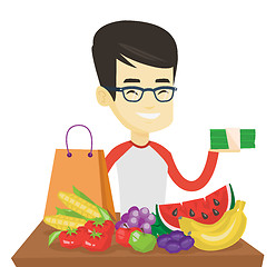 Image showing Man standing at the table with shopping bag.