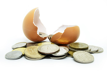 Image showing Cracked egg shell and coins