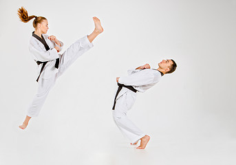 Image showing The karate girl and boy with black belts