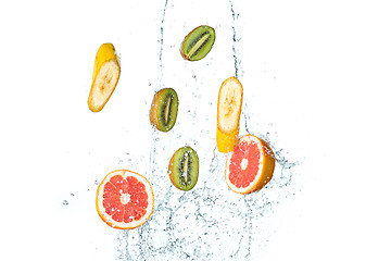 Image showing Fresh fruits falling in water splash, isolated on white background