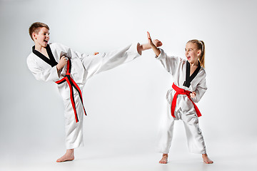 Image showing The studio shot of group of kids training karate martial arts