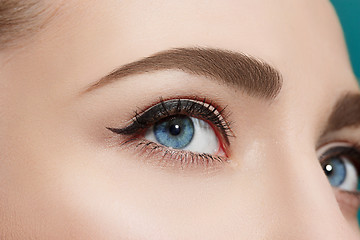 Image showing Beautiful eye close up on blue background.