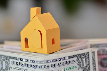 Image showing Miniature paper made house stand on  money