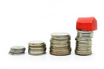 Image showing Coins stacked up in piles with color house