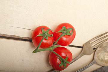 Image showing ripe cherry tomatoes over white wood